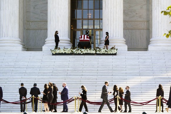 People pay respects as Justice Ruth Bader Ginsburg lies in repose under the Portico at the top of the front steps of the U.S. Supreme Court building on Wednesday, Sept. 23, 2020, in Washington. Ginsbu ...