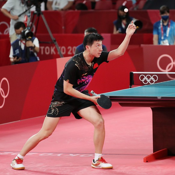 epa09380248 Ma Long of China in action against Fan Zhendong of China (not pictured) during the Table Tennis Men&#039;s Singles Gold Medal Match of the Tokyo 2020 Olympic Games at the Tokyo Metropolita ...