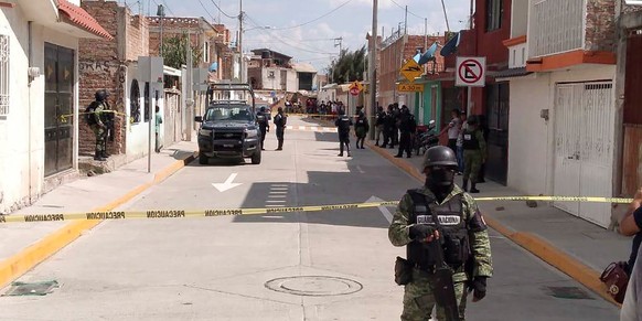 epa08470679 Members of the National Guard protect the area where ten people were killed in the municipality of Irapuato, Guanajuato state, Mexico, 06 June 2020. Ten people were shot dead in a drug add ...
