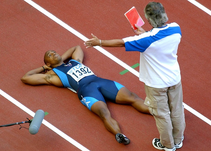 ** FILE ** An unidentified race official shows the red card to Jon Drummond of the USA, who was disqualified for a false start in the second round of the men&#039;s 100-meter event, at the World Athle ...