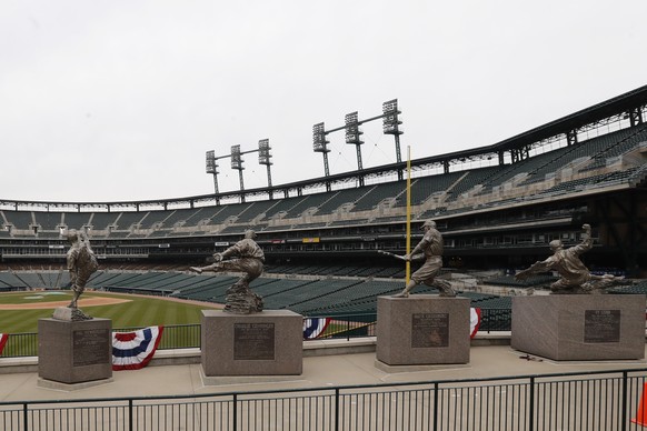 The statues of, from left, Hal Newhouser, Charlie Gehringer, Hank Greenberg and Ty Cobb stand in left field inside Comerica Park, home of the Detroit Tigers baseball team, Thursday, March 26, 2020, in ...