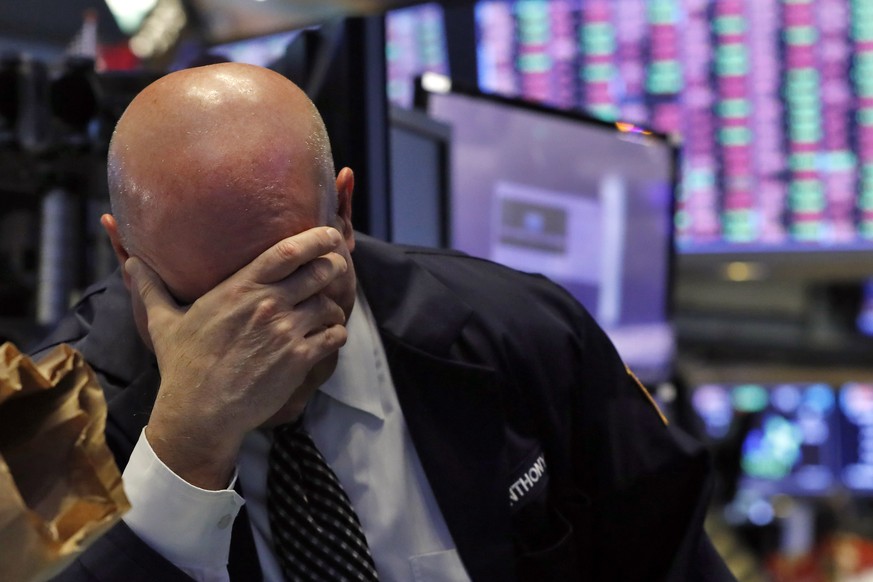 A trader has his head in his hand on the floor of the New York Stock Exchange, Thursday, March 12, 2020. The stock market had its biggest drop since the Black Monday crash of 1987 as fears of economic ...