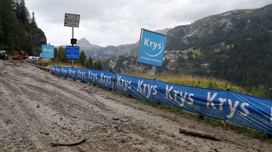 The road of nineteenth stage of the Tour de France cycling race over 126,5 kilometers (78,60 miles) with start in Saint Jean De Maurienne and finish in Tignes is covered in mud, Friday, July 26, 2019. ...
