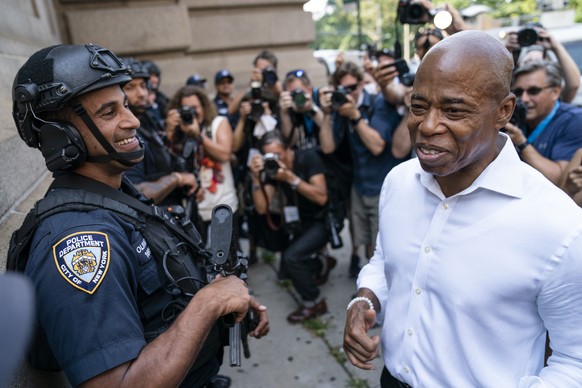 Brooklyn Borough President and a Democratic mayoral candidate Eric Adams greets NYPD officers as participants gather for a march through the financial district during a parade honoring essential worke ...