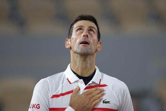 Serbia&#039;s Novak Djokovic celebrates winning his the quarterfinal match of the French Open tennis tournament against Spain&#039;s Pablo Carreno Busta in four sets, 4-6, 6-2, 6-3, 6-4, at the Roland ...