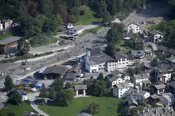 epa06162692 A general aerial view showing as mud rushes towards the village after another eruption, in Bondo, Graubuenden in South Switzerland, 25 August 2017. The village had been hit by a massive la ...