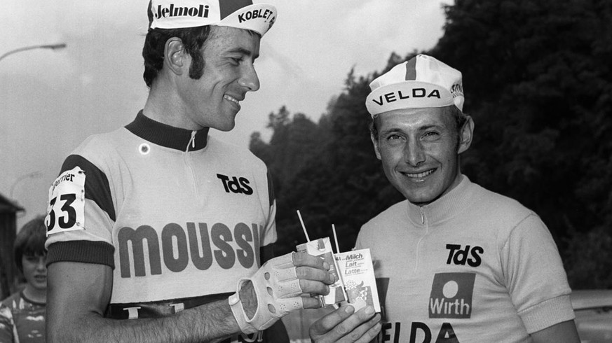 Die beiden Rivalen Ueli Sutter, links, und Michel Pollentier, rechts, stossen am 23. Juni 1977 in Buerglen, Kanton Uri, vor dem Start der 9. Etappe der Tour de Suisse mit Milch auf eine gute Fahrt an. ...