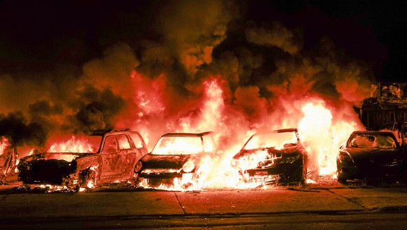 epa08623796 Automobiles burn after being set ablaze during a second night of unrest in the wake of the shooting of Jacob Blake by police officers, in Kenosha, Wisconsin, USA, 24 August 2020. According ...