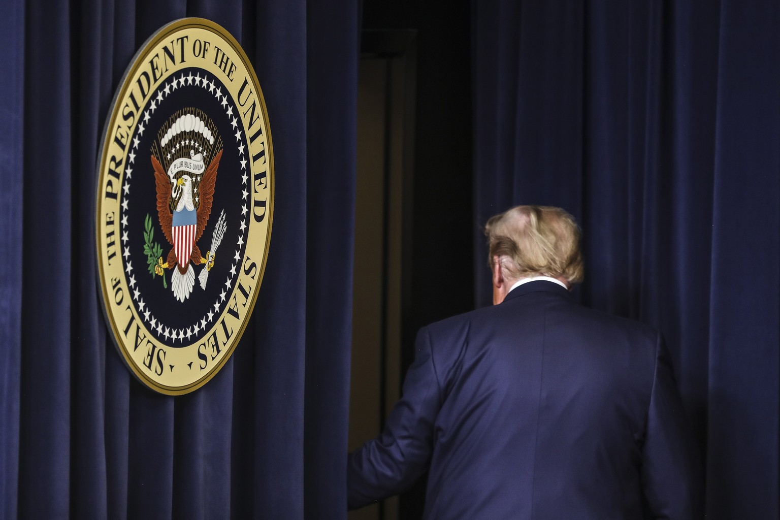epa08871219 US President Donald J. Trump leaves after his speech during an Operation Warp Speed Vaccine Summit in the South Court Auditorium of the of the Eisenhower Executive Office Building at the W ...