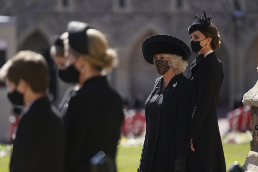 Camilla, the Duchess of Cornwall, second right and Kate, the Duchess of Cambridge stand outside of St George&#039;s Chapel ahead of Britain Prince Philip&#039;s funeral at Windsor Castle, Windsor, Eng ...