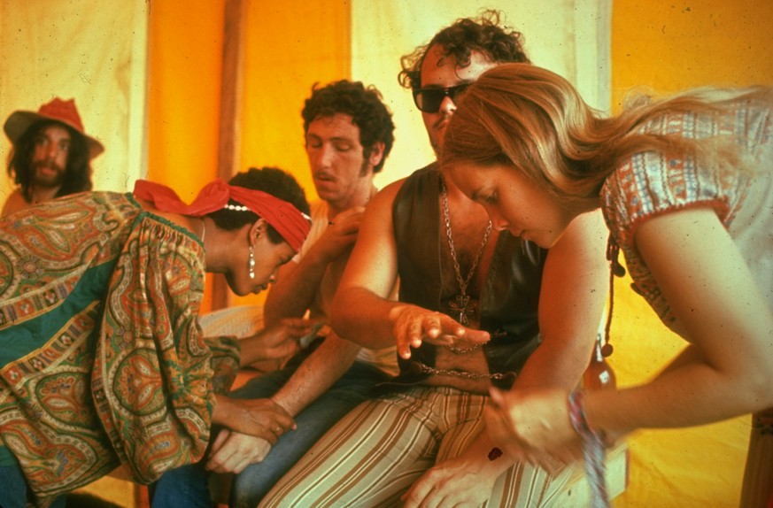 NEW YORK, UNITED STATES - AUGUST 1969: Two unidentified women giving medical care to unidentified men, during the Woodstock Music &amp; Art Fair. (Photo by John Dominis/The LIFE Picture Collection via ...