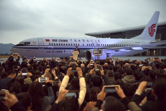 epa07428456 (FILE) - People celebrate the delivery of a Boeing 737 Max 8 airliner for Air China, the first product of the new 737 Completion and Delivery Center jointly run by Boeing and its Chinese r ...