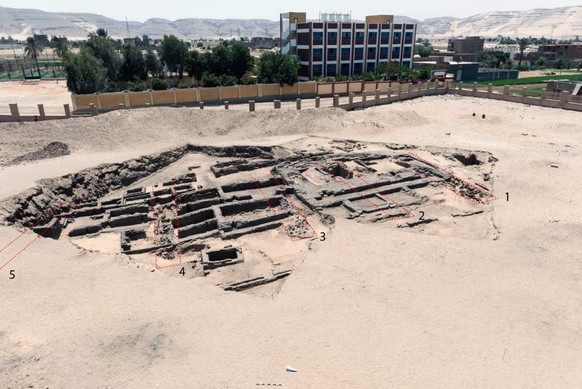 epa09012933 An undated handout photo made available by the Egyptian Department of Antiquities on 14 February 2021 shows the remains of a brewery uncovered in the ancient city of Abydos at Sohag Govern ...