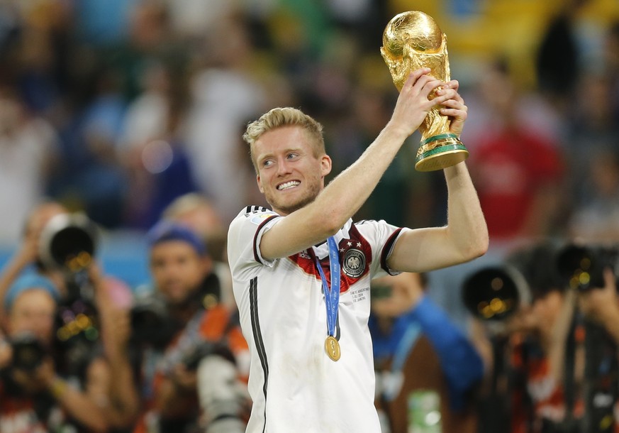 Germany&#039;s Andre Schuerrle lifts the trophy after the World Cup final soccer match between Germany and Argentina at the Maracana Stadium in Rio de Janeiro, Brazil, Sunday, July 13, 2014. Former Ge ...