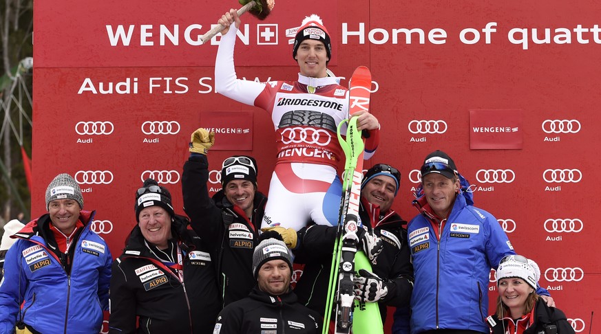 First placed Carlo Janka, center, of Switzerland celebrates with members of Swiss Ski on the podium after the Slalom run of the men&#039;s Super Combined, SC, race of the FIS Alpine Ski World Cup seas ...