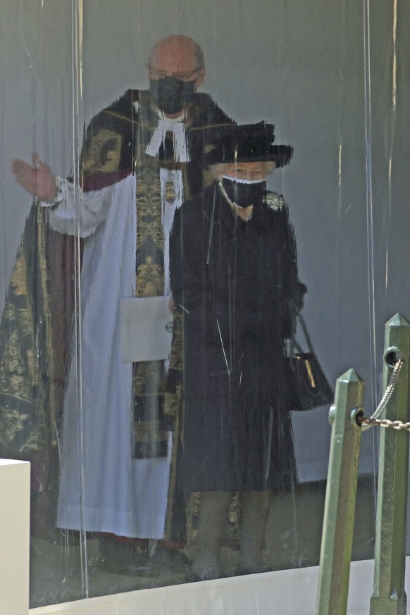 Queen Elizabeth II with The Dean of Windsor watch the procession at the Galilee Porch of St George&#039;s Chapel, Windsor Castle, Windsor, England, Saturday April 17, 2021, during the funeral of Brita ...