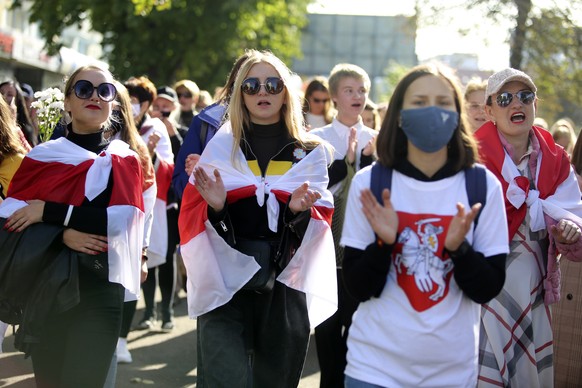 Women wearing old Belarusian national flags attend an opposition rally to protest the official presidential election results in Minsk, Belarus, Saturday, Sept. 19, 2020. Daily protests calling for the ...