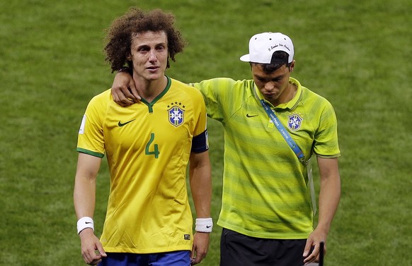 Brazil&#039;s David Luiz, left, reacts as he leaves the pitch comforted by teammate Thiago Silva during the World Cup semifinal soccer match between Brazil and Germany at the Mineirao Stadium in Belo  ...