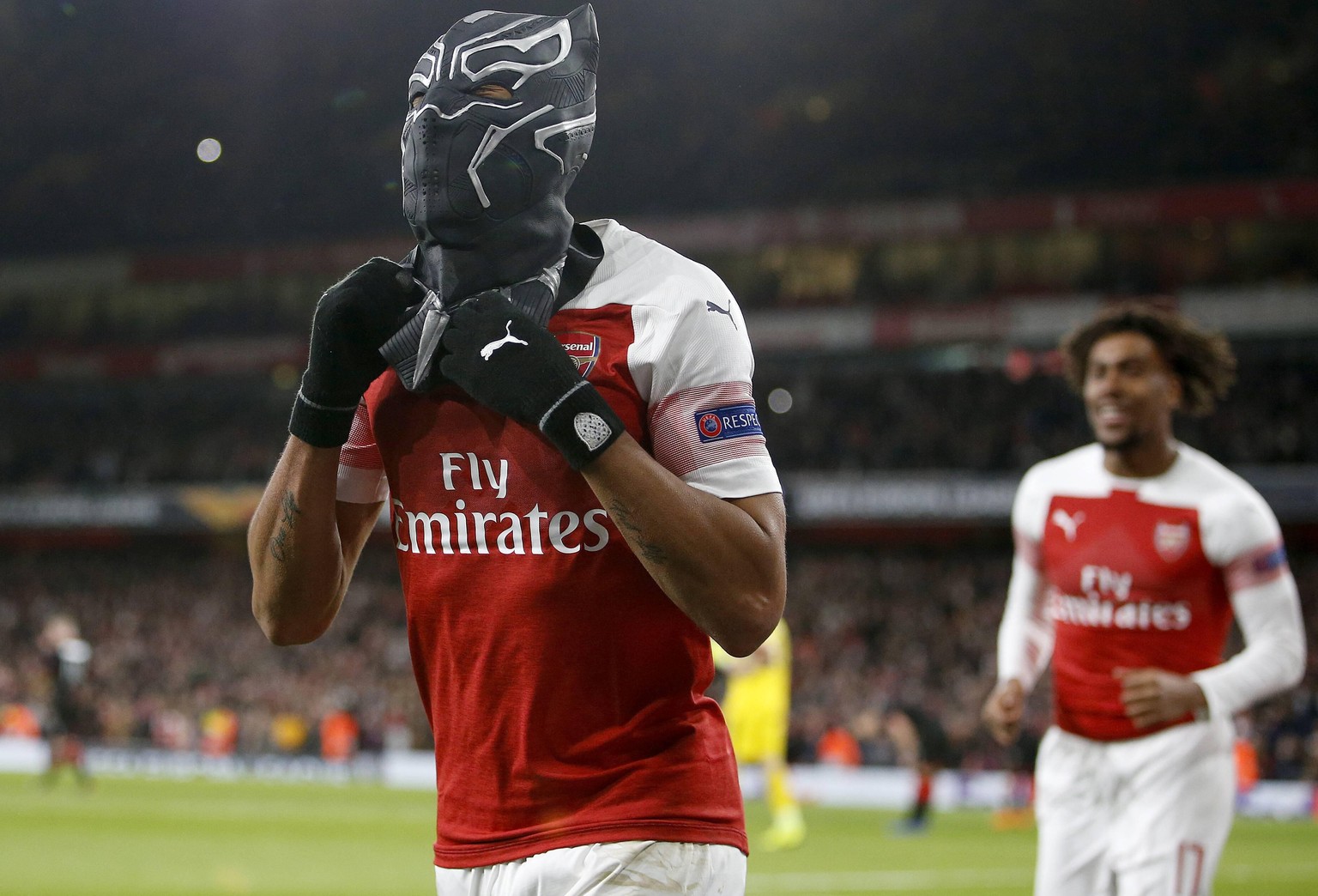 190315 -- LONDON, March 15, 2019 -- Pierre-Emerick Aubameyang of Arsenal celebrates scoring the third goal by putting on a mask of Super Hero Black Panther during the Europa League Round of 16 second  ...