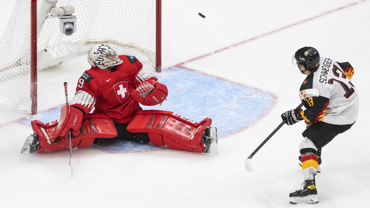 Germany&#039;s Markus Schweiger (13) is stopped by Switzerland goalie Thibault Fatton (29) during the second period of an IIHF World Junior Hockey Championship game Wednesday, Dec. 30, 2020, in Edmont ...