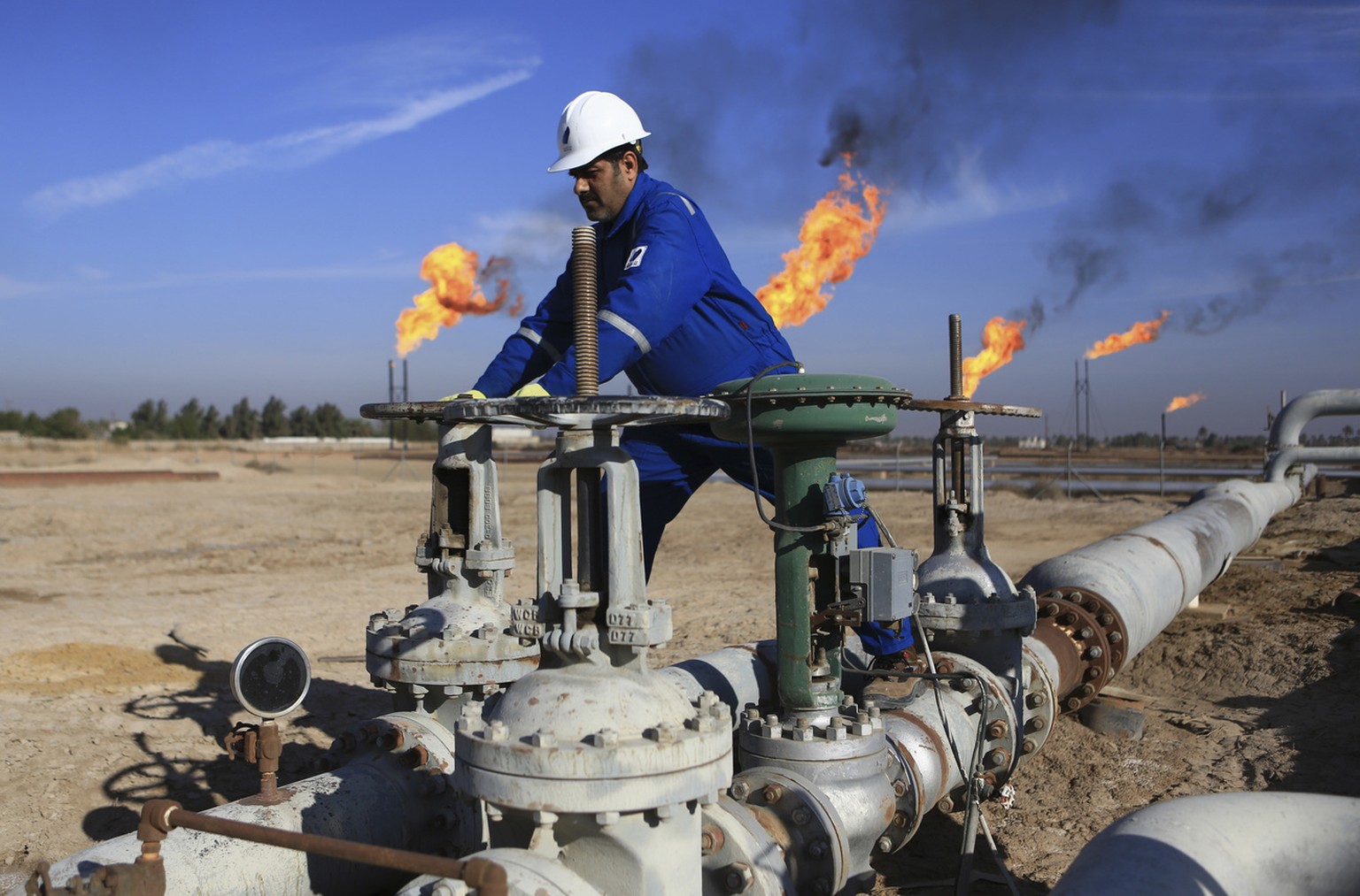 An Iraqi worker operates valves in Nihran Bin Omar field north of Basra, 340 miles (550 kilometers) southeast of Baghdad, Iraq, Thursday, Jan. 12, 2017. Iraq&#039;s state-run South Gas Company inaugur ...