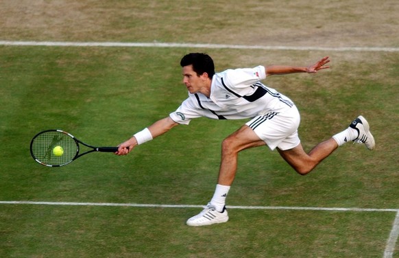 Britain&#039;s Tim Henman plays a forehand return to Mark Philippoussis of Australia during their fourth round Centre Court match at the All England Lawn Tennis Championships in Wimbledon, Monday 28 J ...