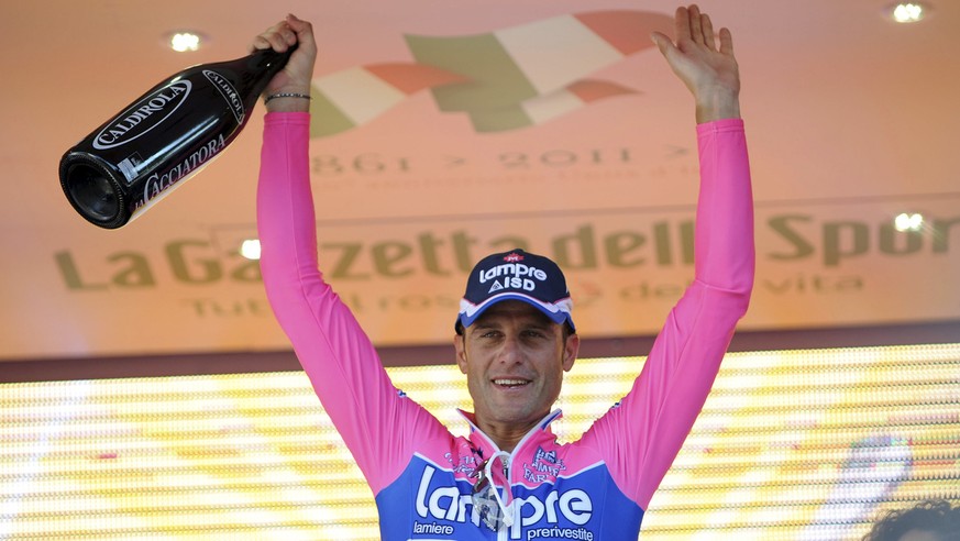 Italy&#039;s Alessandro Petacchi celebrates on the podium after winning the second stage of the Giro d&#039;Italia, Tour of Italy cycling race from Alba to Parma, Sunday, May 8, 2011. (AP Photo/Giovan ...