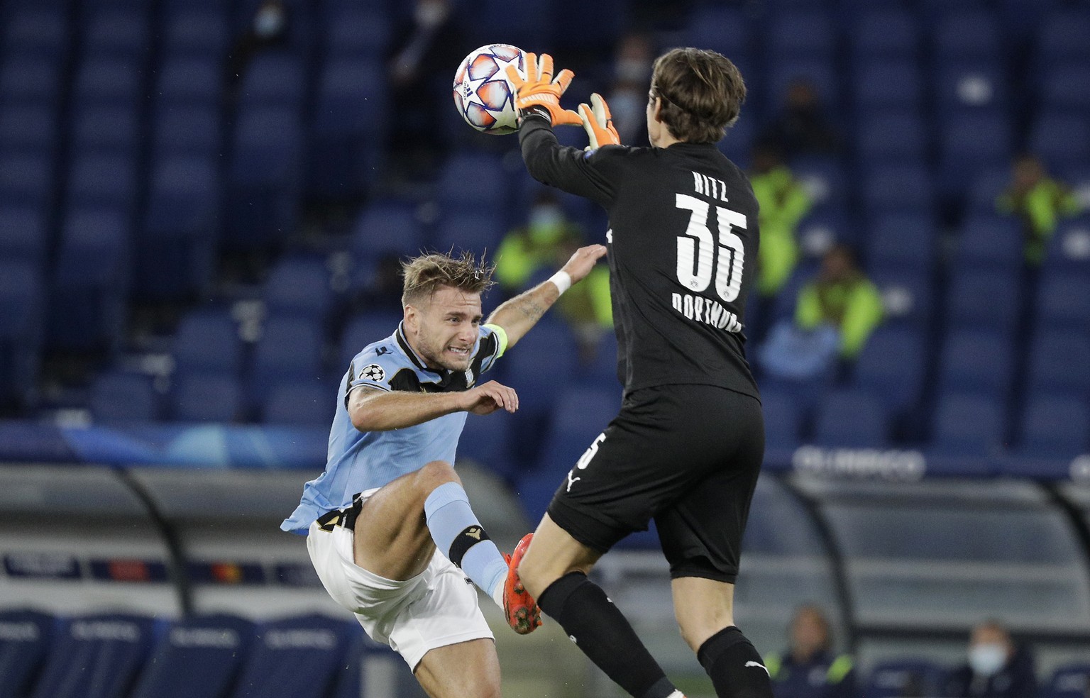 Dortmund&#039;s goalkeeper Marwin Hitz, right, saves on Lazio&#039;s Ciro Immobile during the Champions League group F soccer match between Lazio and Borussia Dortmund at the Olympic stadium in Rome,  ...