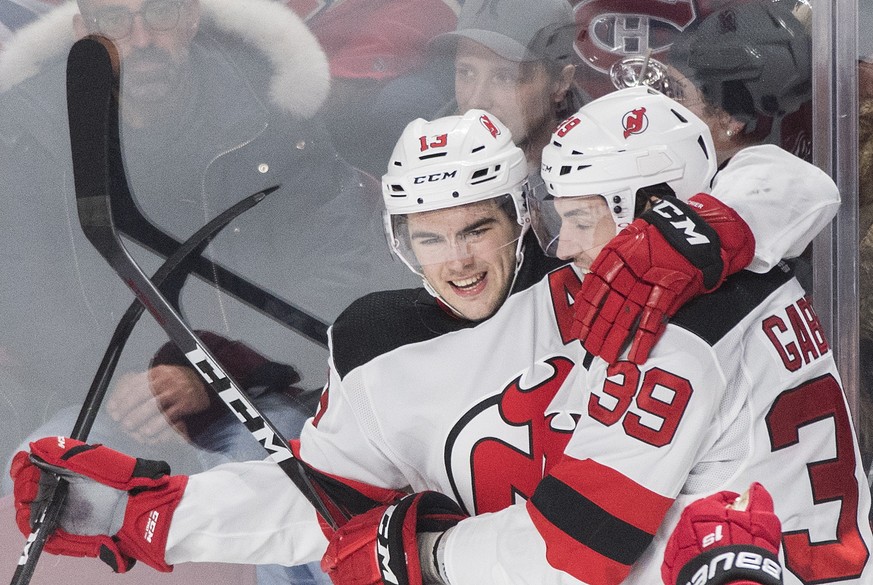 New Jersey Devils&#039; Nico Hischier (13) celebrates with teammate Kurtis Gabriel after scoring against the Montreal Canadiens during the third period of an NHL hockey game, Saturday, Feb. 2, 2019 in ...