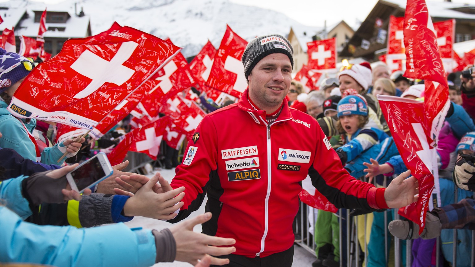 Beat Feuz of Switzerland, 2nd place, celebrates with fans during the prize giving ceremony after the men&#039;s downhill race of the FIS Alpine Ski World Cup season at the Lauberhorn, in Wengen, Switz ...