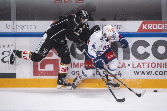 From left, Lugano?s player Jani Lajunen and Zurich&#039;s player Dominik Diem, during the preliminary round game of National League A (NLA) Swiss Championship 2019/20 between HC Lugano and ZSC Lions a ...