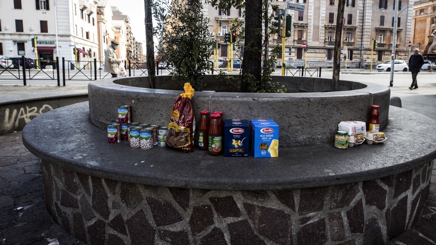 epa08338628 A view of grocery items for people and families in need to take, sitting on the bench of a small piazza, in Rome, Italy, 02 April 2020, during the ongoing novel coronavirus disease (COVID- ...