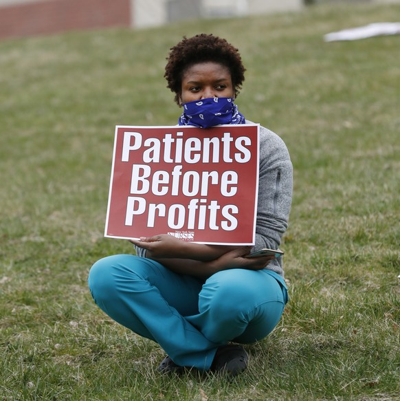A nurse demonstrates outside the emergency entrance to Jacobi Medical Center in the Bronx borough of New York Saturday, March 28, 2020, as she joined other nursing staff demanding more personal protec ...
