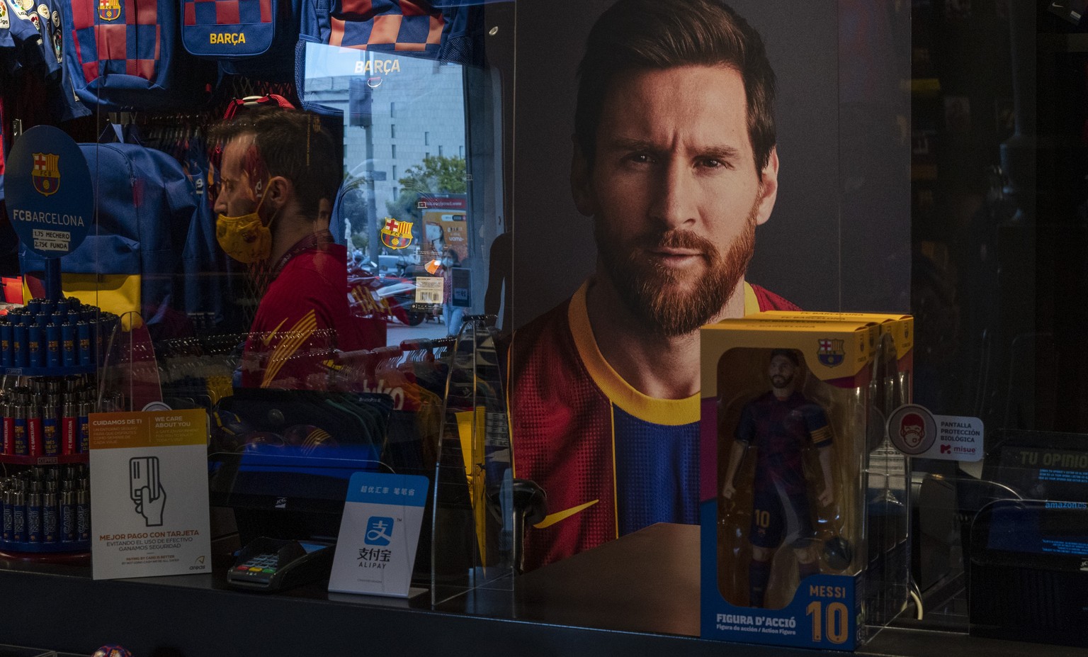 A poster with the face of Barcelona soccer player Lionel Messi is displayed at a F.C. Barcelona store in Barcelona, Spain on Tuesday, Sept. 1, 2020. Barcelona is banking on a face-to-face meeting with ...