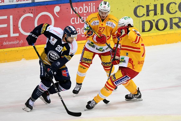 From left Ambri&#039;s player Elias Bianchi, Biel&#039;s player Yannick Rathgeb and Biel&#039;s player Marc Antoine Pouliot, during the preliminary round game of National League A (NLA) Swiss Champion ...