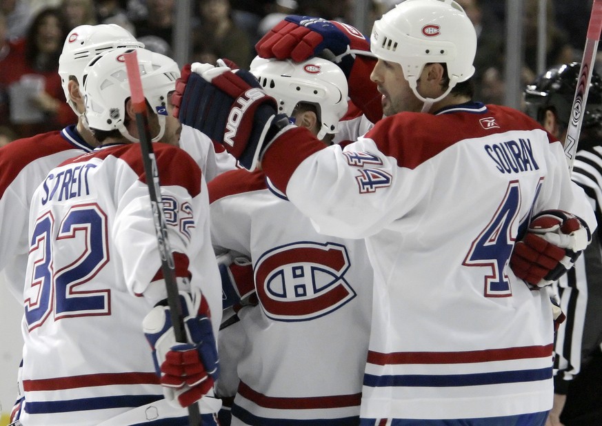 Montreal Canadiens defenseman Sheldon Souray (44) celebrates with teammates, including Mark Streit, of Switzerland, after scoring a first-period power play goal against the Tampa Bay Lightning during  ...