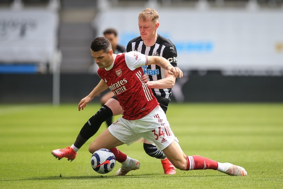 epa09173669 Sean Longstaff (R) of Newcastle in action against Granit Xhaka (L) of Arsenal during the English Premier League soccer match between Newcastle United and Arsenal FC in Newcastle, Britain,  ...
