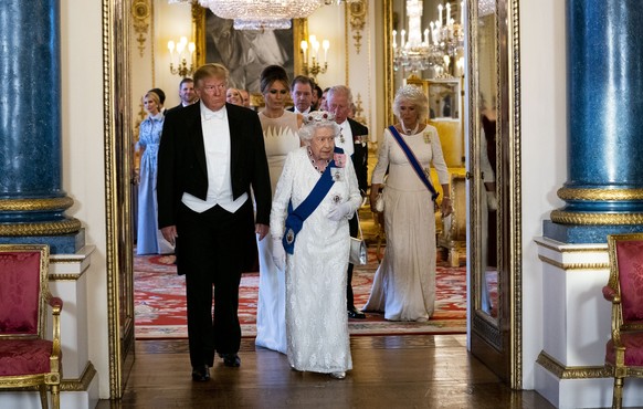 President Donald Trump and first lady Melania Trump walk with Queen Elizabeth II as they make their way into the Music Room for a State Banquet at Buckingham Palace, Monday, June 3, 2019, in London. ( ...