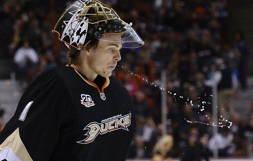 Anaheim Ducks goalie Jonas Hiller (1) releases a stream of water during a break in the action against the Nashville Predators in the first period of an NHL hockey game in Anaheim, Calif., Friday, Apri ...