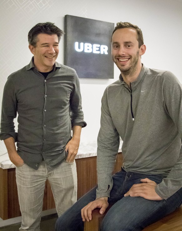 Uber CEO Travis Kalanick, left, and Anthony Levandowski, co-founder of Otto, pose for a photo in the lobby of Uber headquarters, Thursday, Aug. 18, 2016, in San Francisco. Uber announced that it is ac ...