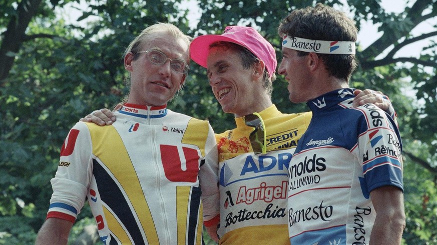 United States Greg LeMond, center, winner of the 76th Tour de France cycling classic, poses next to Frances Laurent Fignon, left, second, and Spains Pedro Delgado, third, on the podium, Sunday, July 2 ...