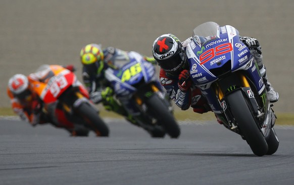 Jorge Lorenzo of Spain steers his Yamaha tailed by Italy&#039;s Valentino Rossi on Yamaha and Spain&#039;s Marc Marquez on Honda during the Japanese Grand Prix at Twin Ring Motegi circuit in Motegi, n ...