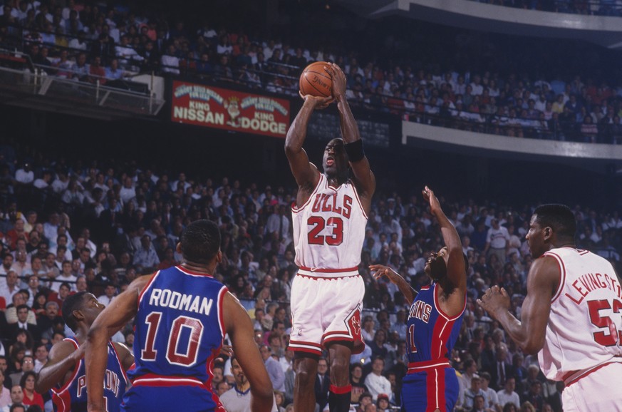 CHICAGO - 1991: Michael Jordan #23 of the Chicago Bulls jumps to shoot a basket against the Detroit Pistons as Cliff Levingston #53 of the Bulls, Dennis Rodman #10 of the Pistons and Isiah Thomas #11  ...