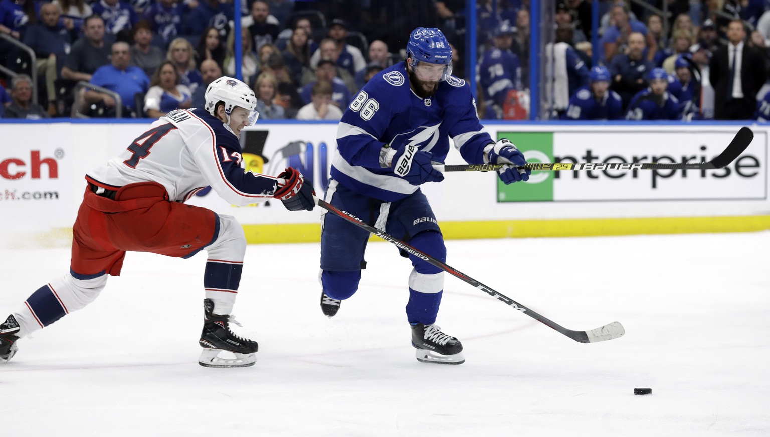 Columbus Blue Jackets defenseman Dean Kukan (14) tips the puck away from Tampa Bay Lightning right wing Nikita Kucherov (86) during the second period of Game 1 of an NHL Eastern Conference first-round ...