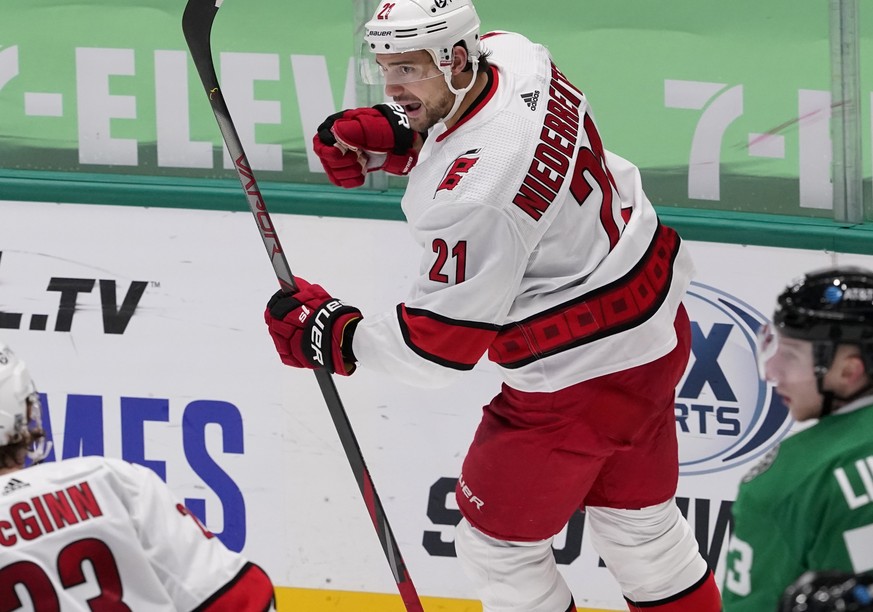 Carolina Hurricanes right wing Nino Niederreiter (21) celebrates his goal as teammate Brock McGinn (23) and Dallas Stars&#039; Esa Lindell, right, look on in the third period of an NHL hockey game in  ...