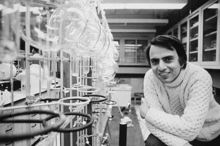 20th March 1974: Portrait of American astronomer and author Carl Sagan (1934 - 1996) leaning his elbows on his knees and smiling in a laboratory at Cornell University, Ithaca, New York. He is wearing  ...
