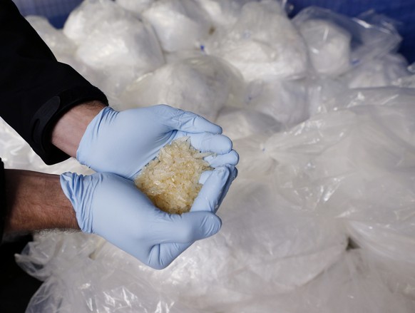 A criminal expert shows Crystal meth at the German federal police in Wiesbaden, Germany, Thursday, Nov.13, 2014. Authorities have seized 2.9 tons of a chemical used to produce crystal meth in an opera ...