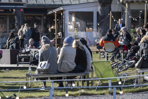 epa08313751 People enjoy the sunny but chilly weather at an outdoor restaurant at Djurgarden in Stockholm, Sweden, on March 22, 2020, amidst the new coronavirus COVID-19 pandemic. EPA/ANDERS WIKLUND S ...