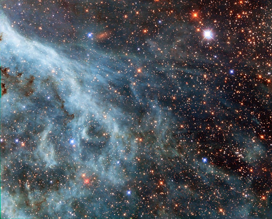 epa04456542 A undated handout image made available by NASA on 21 October 2014 showing part of the Large Magellanic Cloud (LMC), a small nearby galaxy that orbits our galaxy, the Milky Way, and appears ...