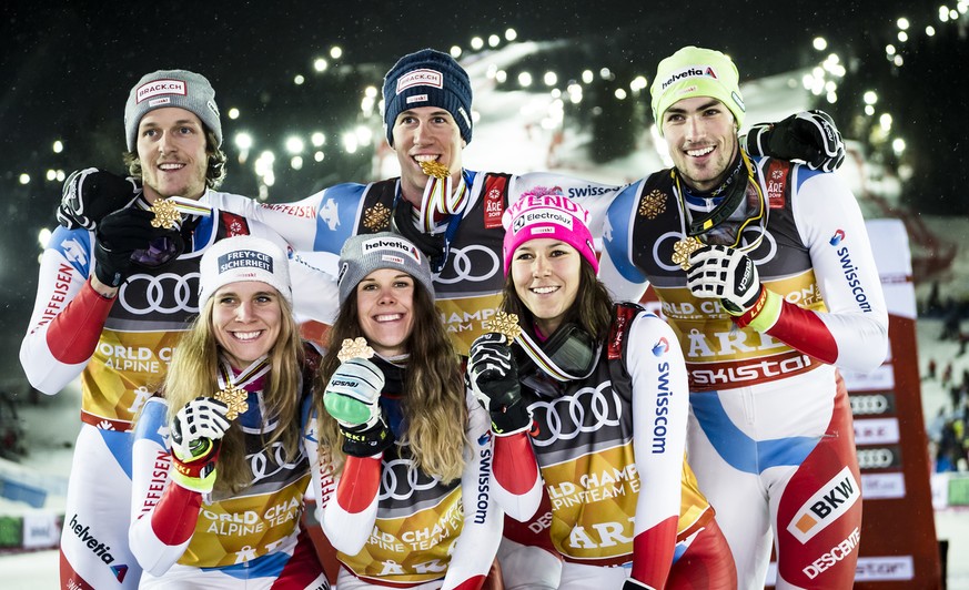 Gold medals, Sandro Simonet, Andrea Ellenberger, Aline Danioth, Ramon Zenhaeusern, Wendy Holdener and Daniel Yule of Switzerland, from left to right, celebrate during the medals ceremony after the Alp ...